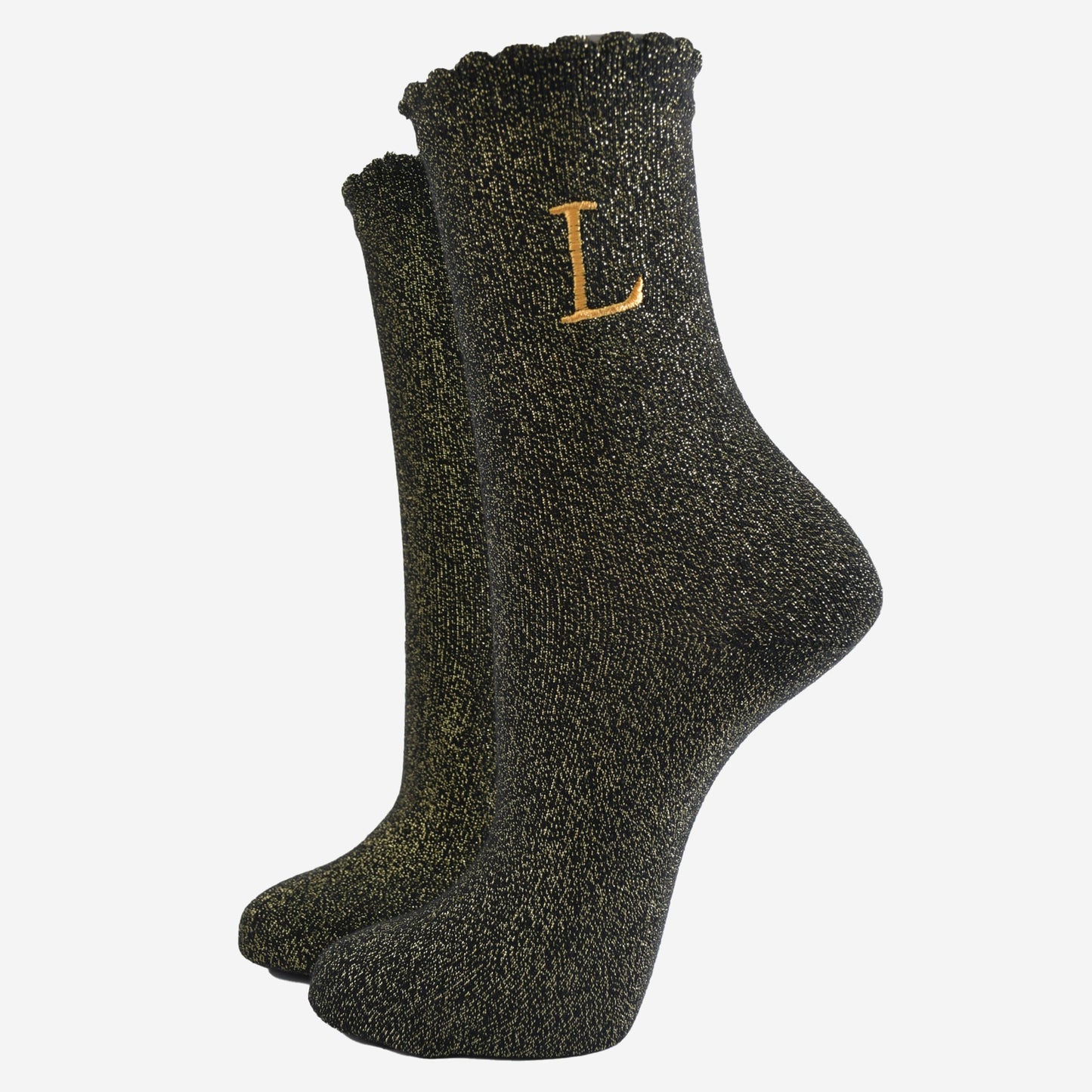 black ankle socks with a scalloped cuff, with an all over gold glitter sparkle and an embroidered gold letter l on the ankle