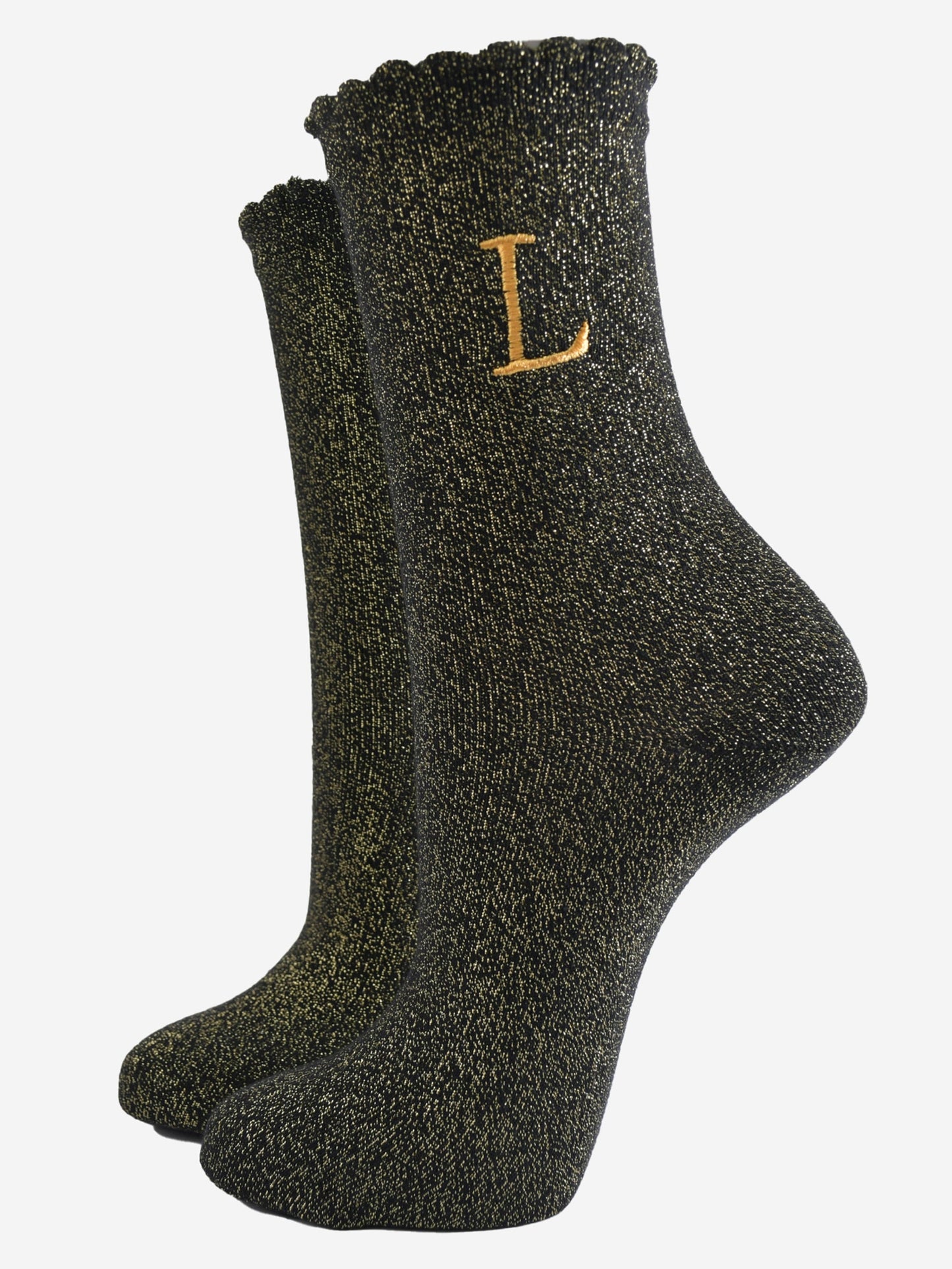 black ankle socks with a scalloped cuff, with an all over gold glitter sparkle and an embroidered gold letter l on the ankle