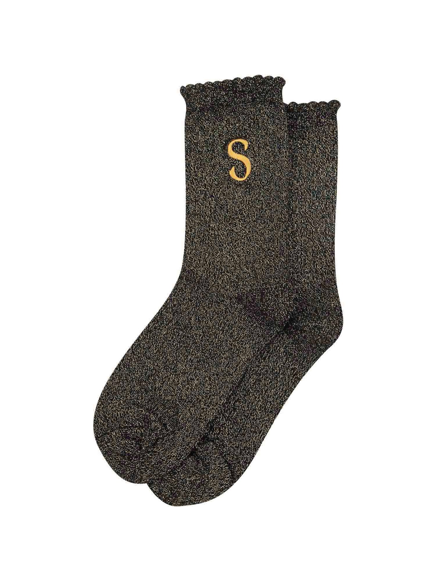 showing the glitter socks laying flat, they have a scalloped cuff and an all over gold sparkle
