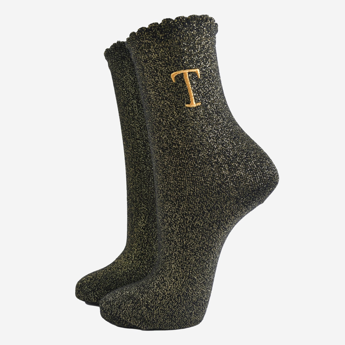 black ankle socks with a scalloped cuff, with an all over gold glitter sparkle and an embroidered gold letter t on the ankle