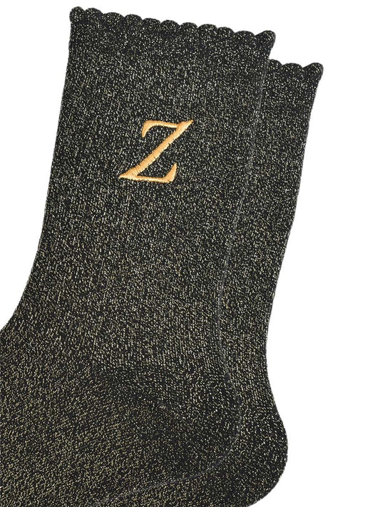 close up of the gold embroidered capital letter z on the ankle of the socks