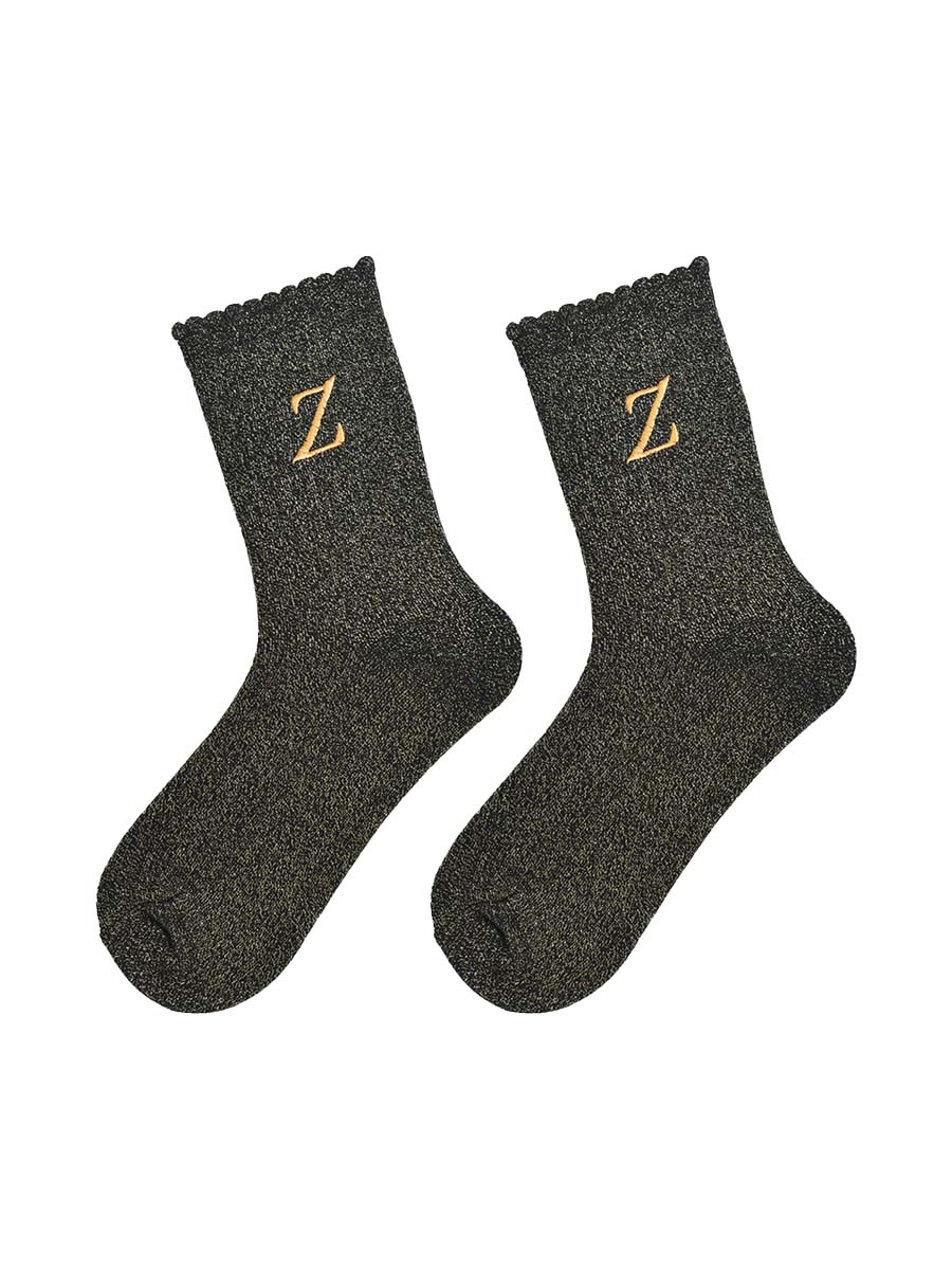 showing the glitter socks laying flat, they have a scalloped cuff and an all over gold sparkle