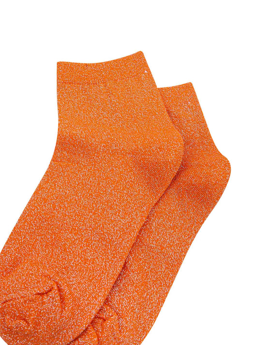 close up of the sparkly glitter effect on the orange anklet socks