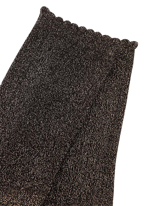 close up of the black and gold sparkly glitter socks, they have a scalloped cuff