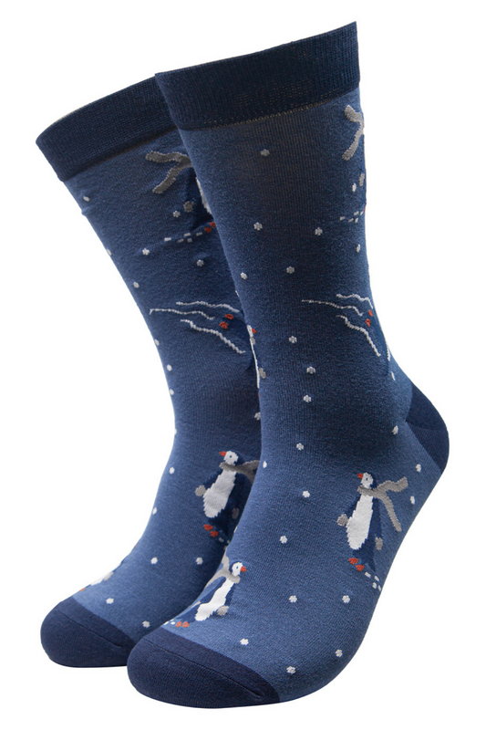 blue bamboo socks with a pattern of ice skating penguins