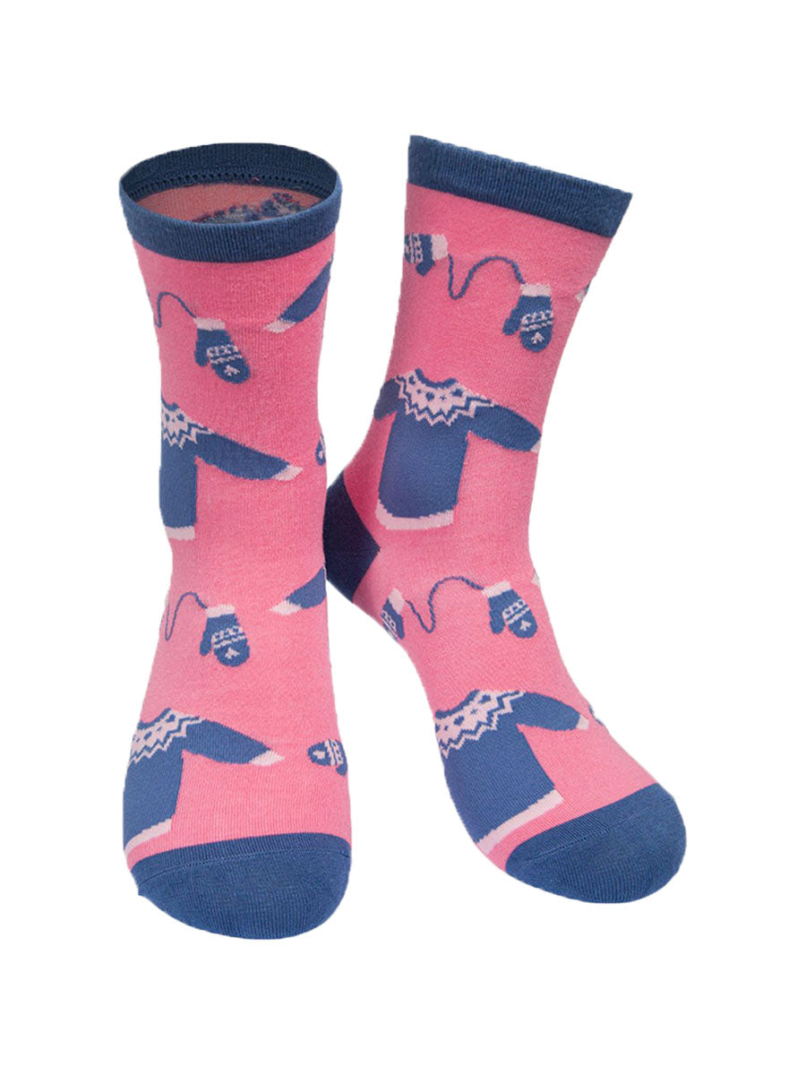 pink and blue bamboo socks with a pattern of xmas jumpers and winter gloves