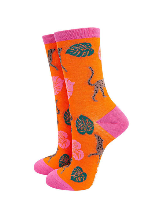 orange bamboo socks with pink and green leaves and brown cheetahs