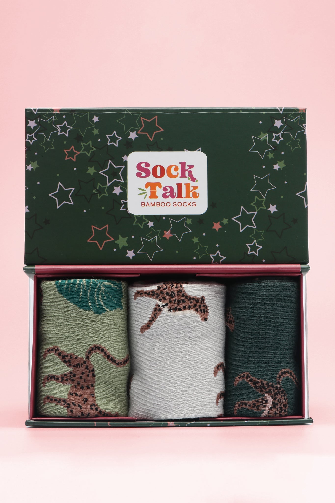 three pairs of cheetah print bamboo socks in a green star print gift box