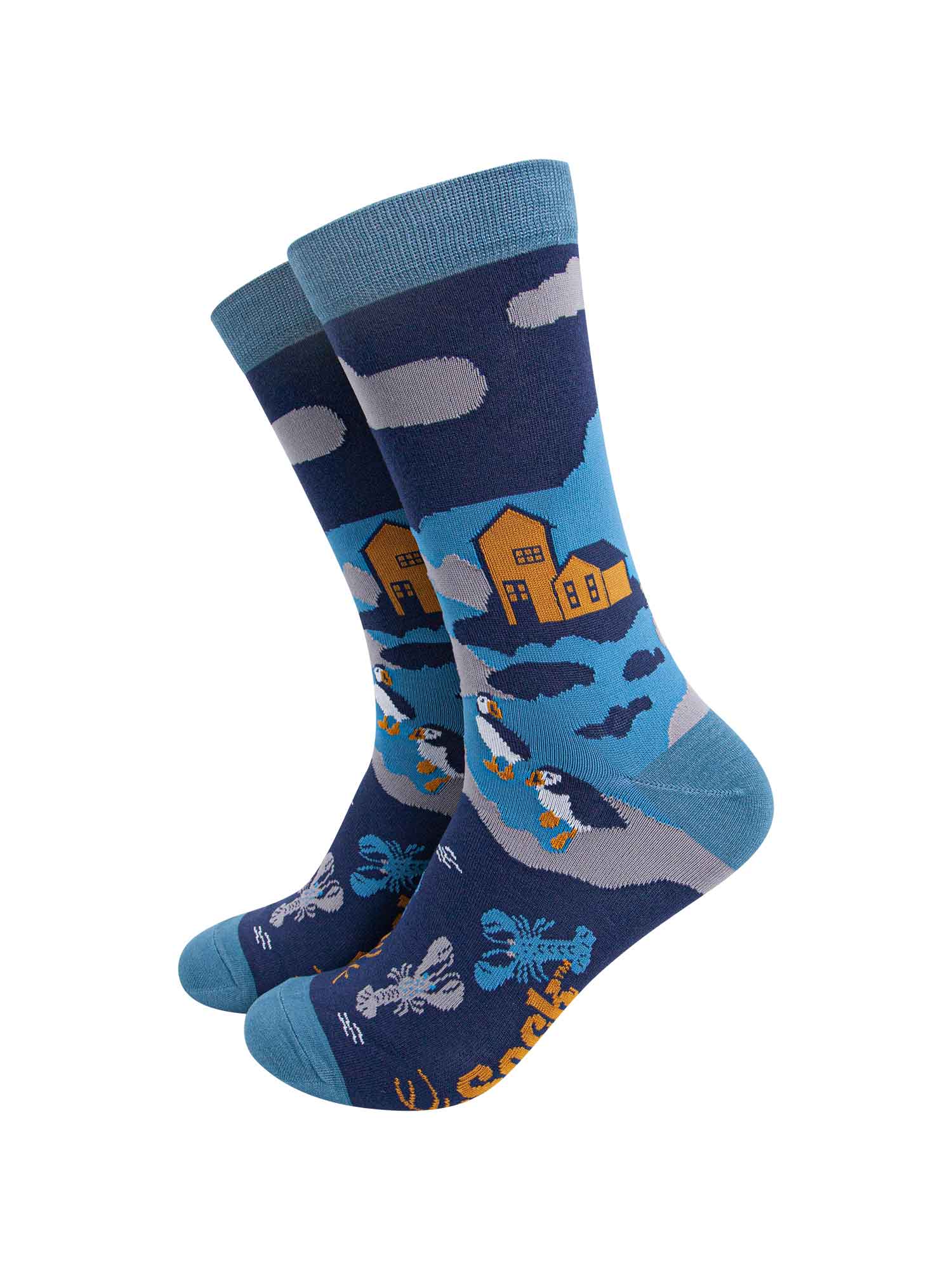blue bamboo socks designed to look like a coastal scene with puffins, lobsters and a shoreline