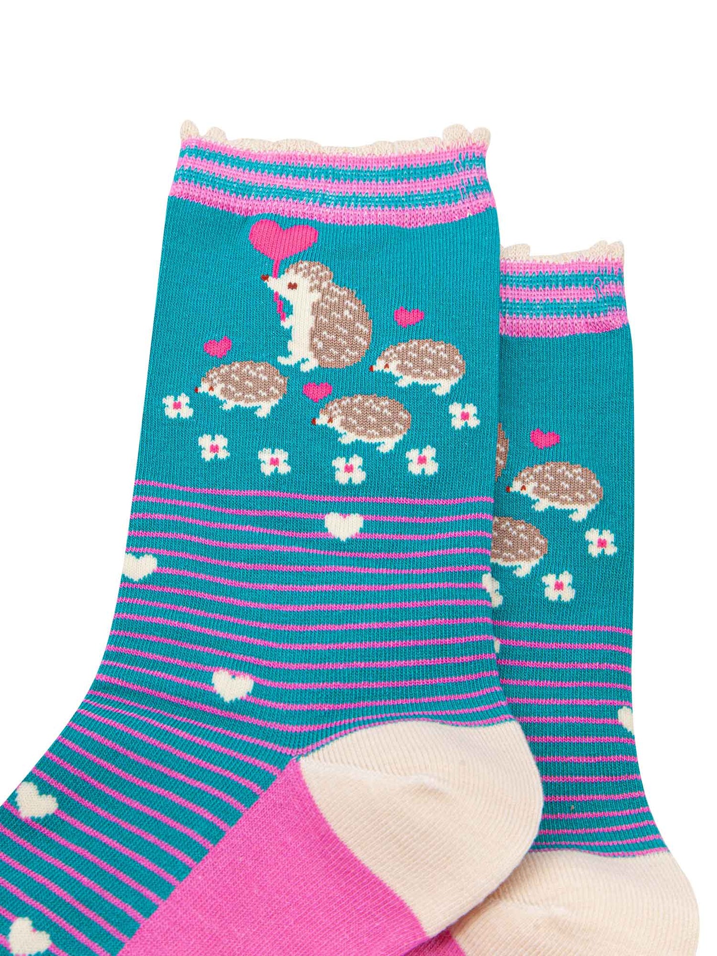 close up of the pattern. there are four hedgehogs on the ankle, one adult and three babies they are beige and each are carrying a fuchsia pink love heart shaped balloon. there are six small white flowers in a semi circle around the bottom of the family. the body of the socks has pink pinstripes and scattered white love hearts.