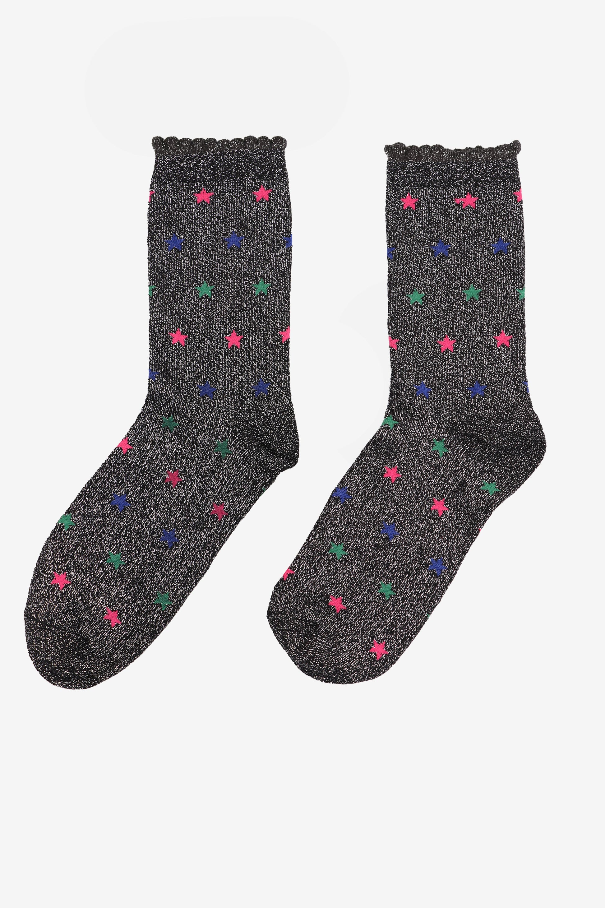 black cotton socks with an all over silver glitter shimmer and blue, pink and green star pattern, the socks have scalloped cuffs