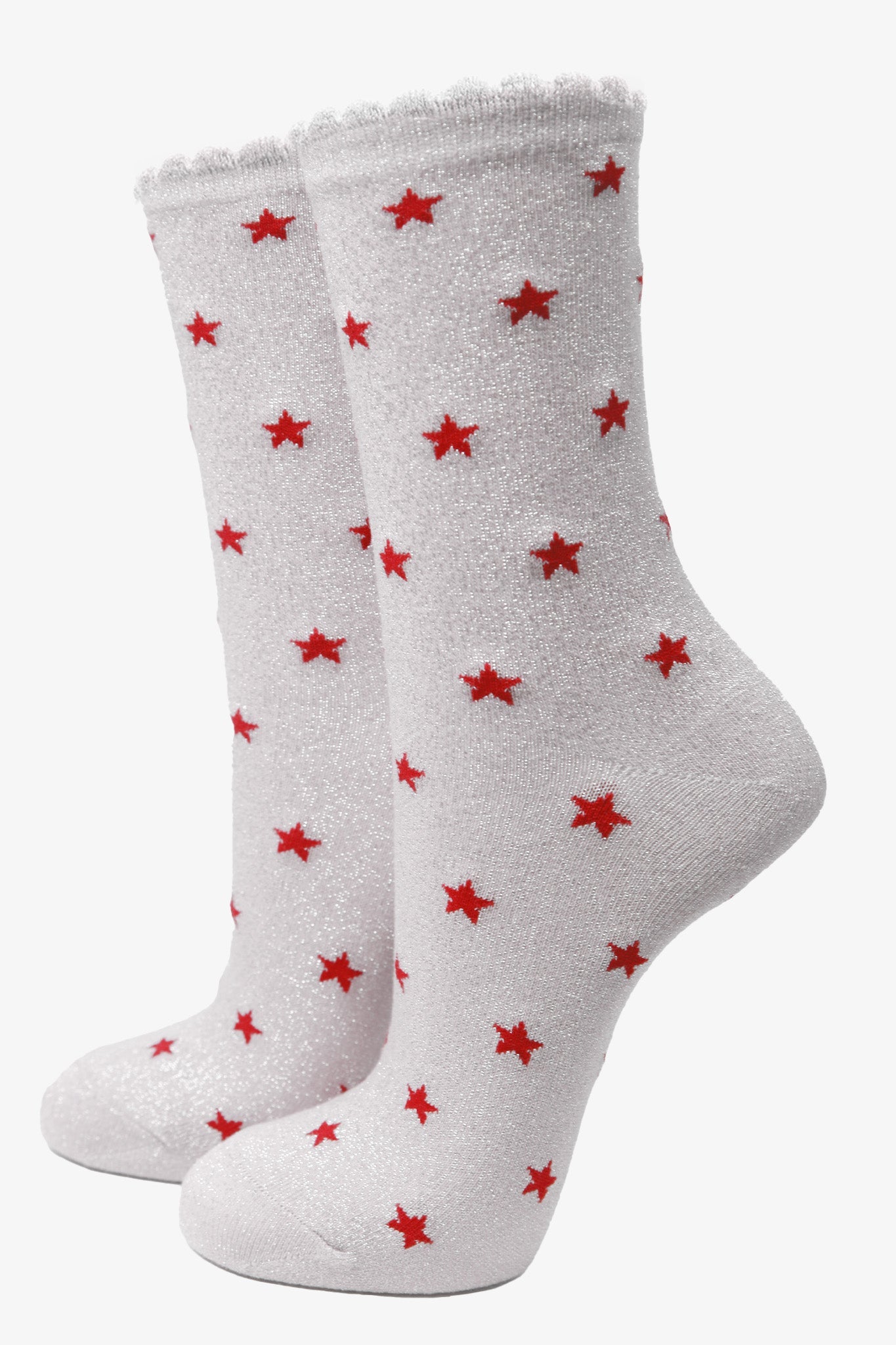 white cotton ankle socks with an all over red star print pattern and silver glitter shimmer, the socks have scalloped cuffs