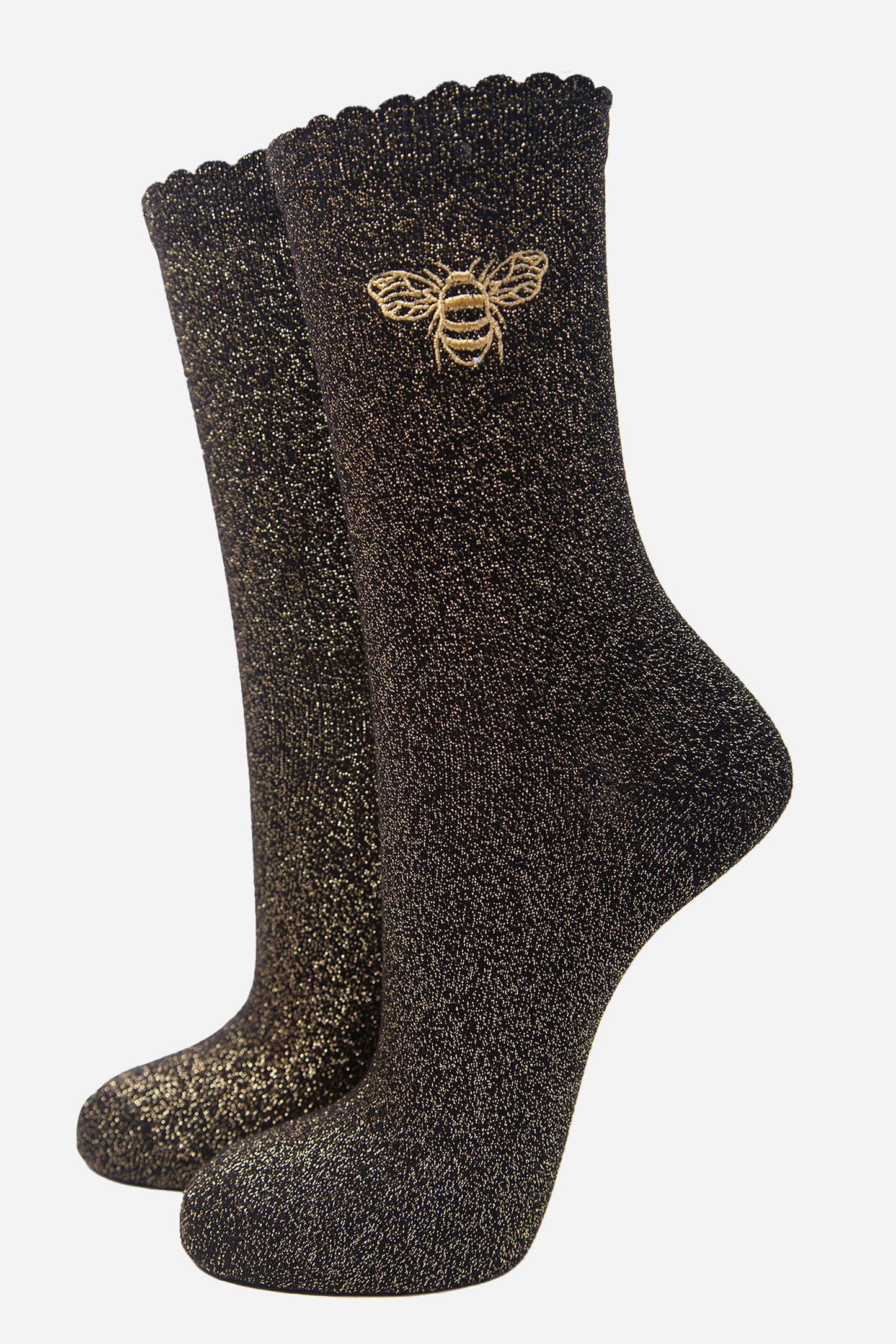 black glitter socks with an all over gold sparkle and a gold embroidered bee on the ankle, the socks have scalloped cuffs