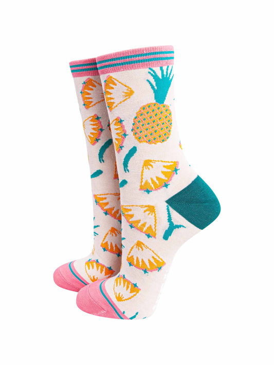 womens cream bamboo socks with an all over yellow pineapple and pinapple slice pattern, with pink toe and pink stiped cuff