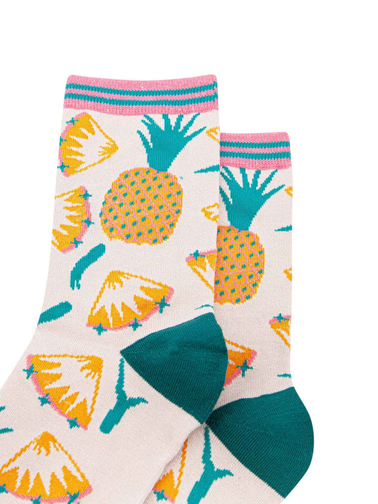 close up of the pineapple pattern on the socks, showing whole pineapples and pineapple slices