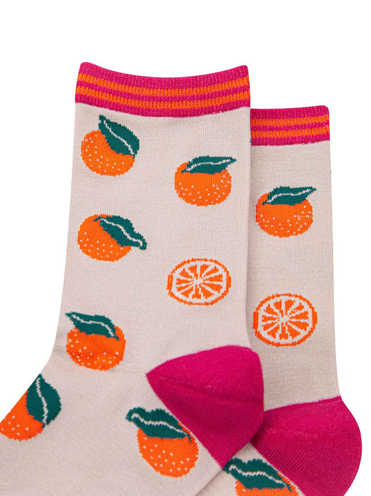close up of the orange fruit pattern on the socks and a close up of the striped cuff