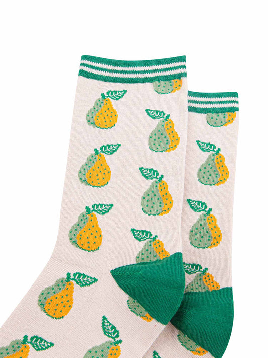 close up of the green and yellow pear fruit print  and striped cuff on the bamboo socks