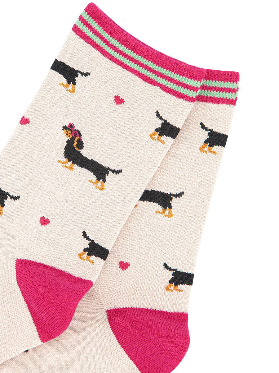 close up of the sausage dog and love heart pattern and striped cuff of the sock
