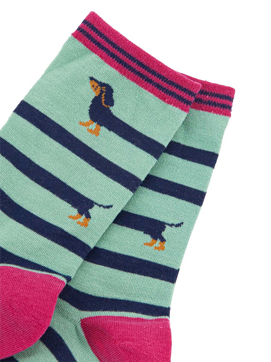 close up of the fun winding sausage dog pattern showing the head and tail of the sausage dog with its elongated body winding around the socks