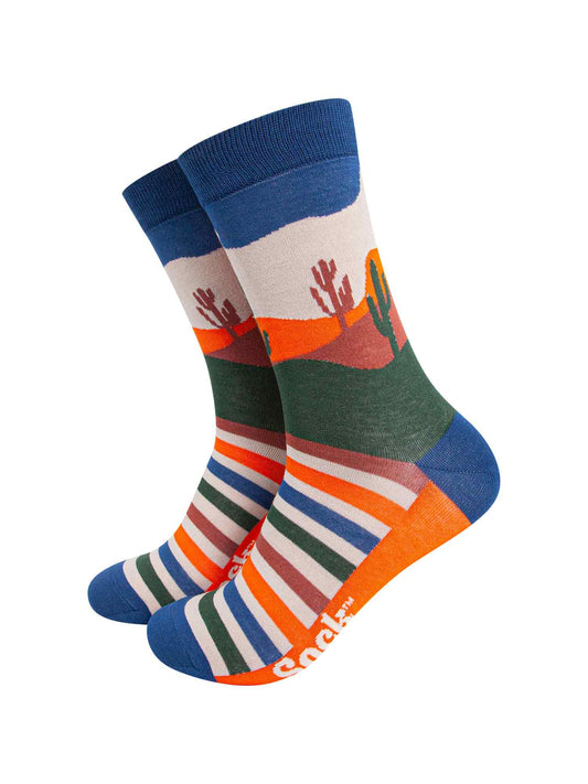 multicoloured bamboo socks featuring a desert sunset design including desert cactus, sunset and an eagle. 