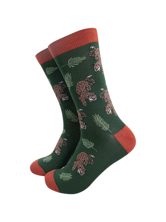 green and orange bamboo socks with an all over pattern featuring a prowling cheetah and jungle leaves