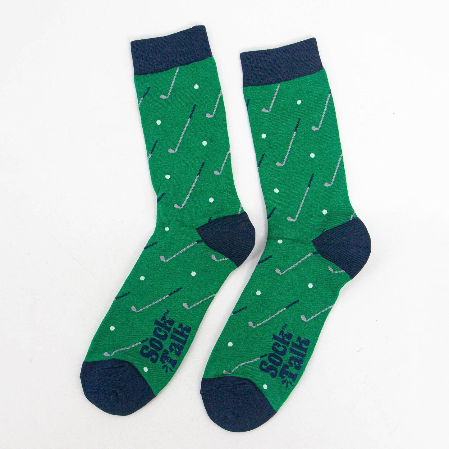 showing the socks laying flat, there is an all over pattern of golf clubs and golf balls on a green background