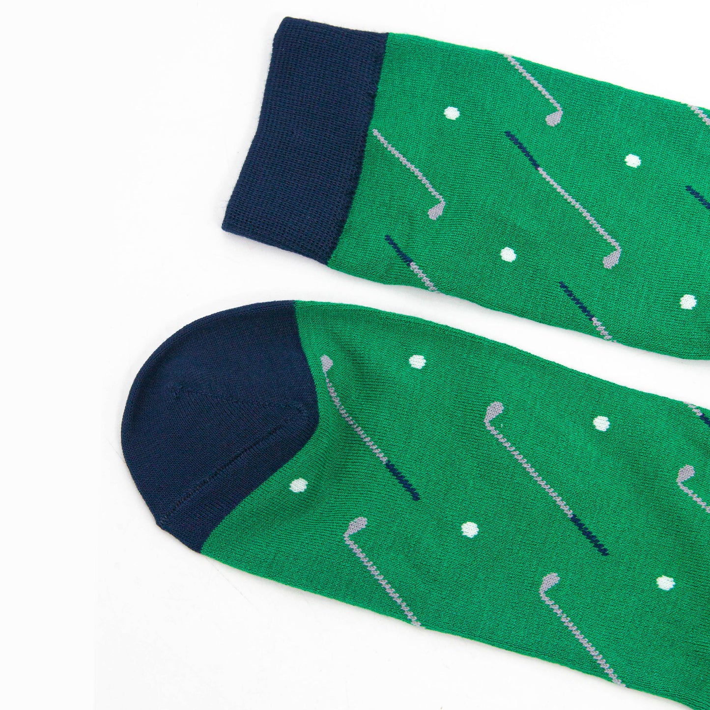 close up of the toe and cuff of the golf socks, both are navy blue in contrast to the green of the socks