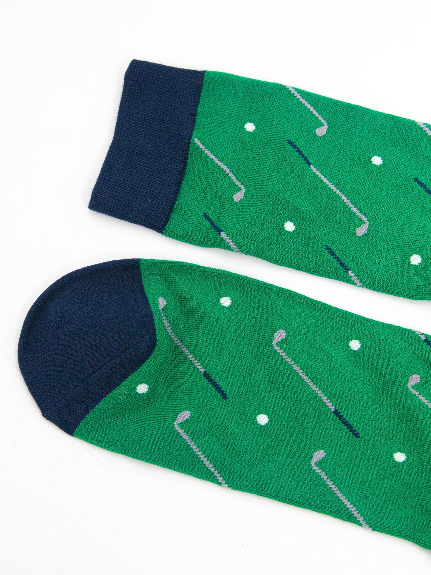 close up of the toe and cuff of the golf socks, both are navy blue in contrast to the green of the socks