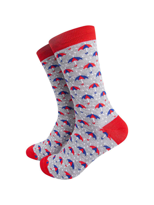 grey dress socks with red heel, toe and cuff with an all over pattern of red and blue umbrellas and white rain drops