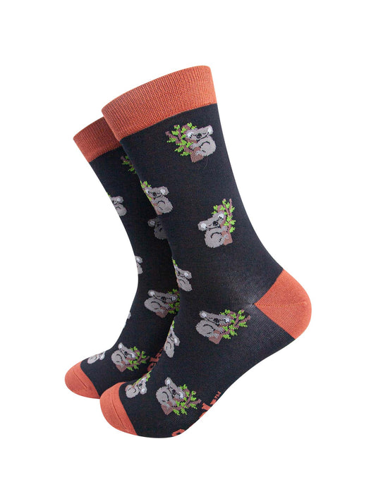 black and bamboo socks with an orange heel, toe and cuff with an all over pattern of sleeping koala bears