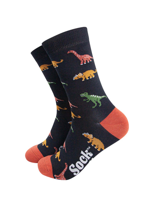black bamboo socks with an all over patten of assorted dinosaurs in multiple colours, green, orange and yellow