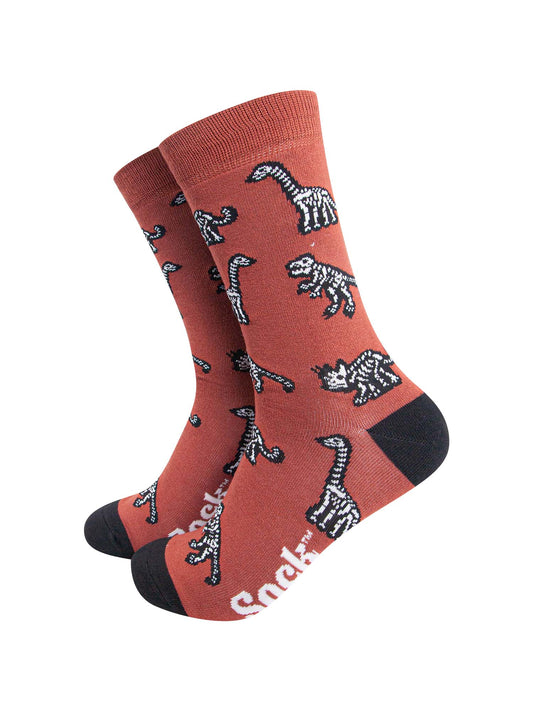 burnt orange and black dress socks featuring an all over dinosaur skeleton pattern in white