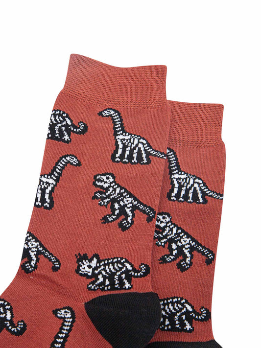 close of the dinosaur skeleton pattern, the bones show the skeleton of a t-rex, triceratops and diplodocus