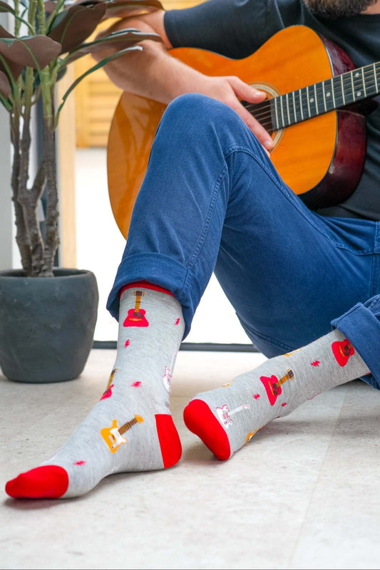 mens-electric-and-acoustic-guitar-print-bamboo-socks-man-posed-with-guitar