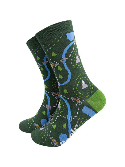 green bamboo socks designed to look like a biker route map featuring a yellow mountain bike, trees and mountains