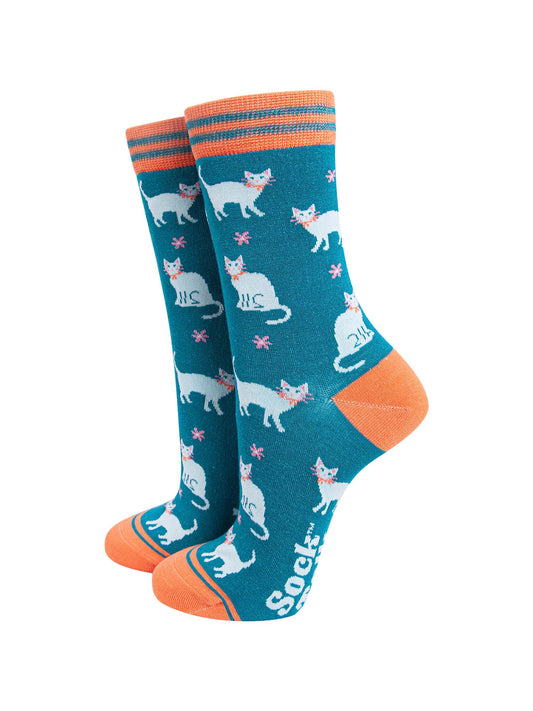 teal bamboo ankle socks with an all over pattern of white cats and pink daisy flowers
