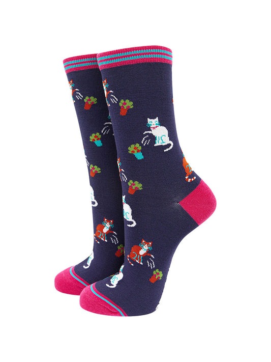 navy blue and pink bamboo socks featuring a funny print with cats knocking over plant pots
