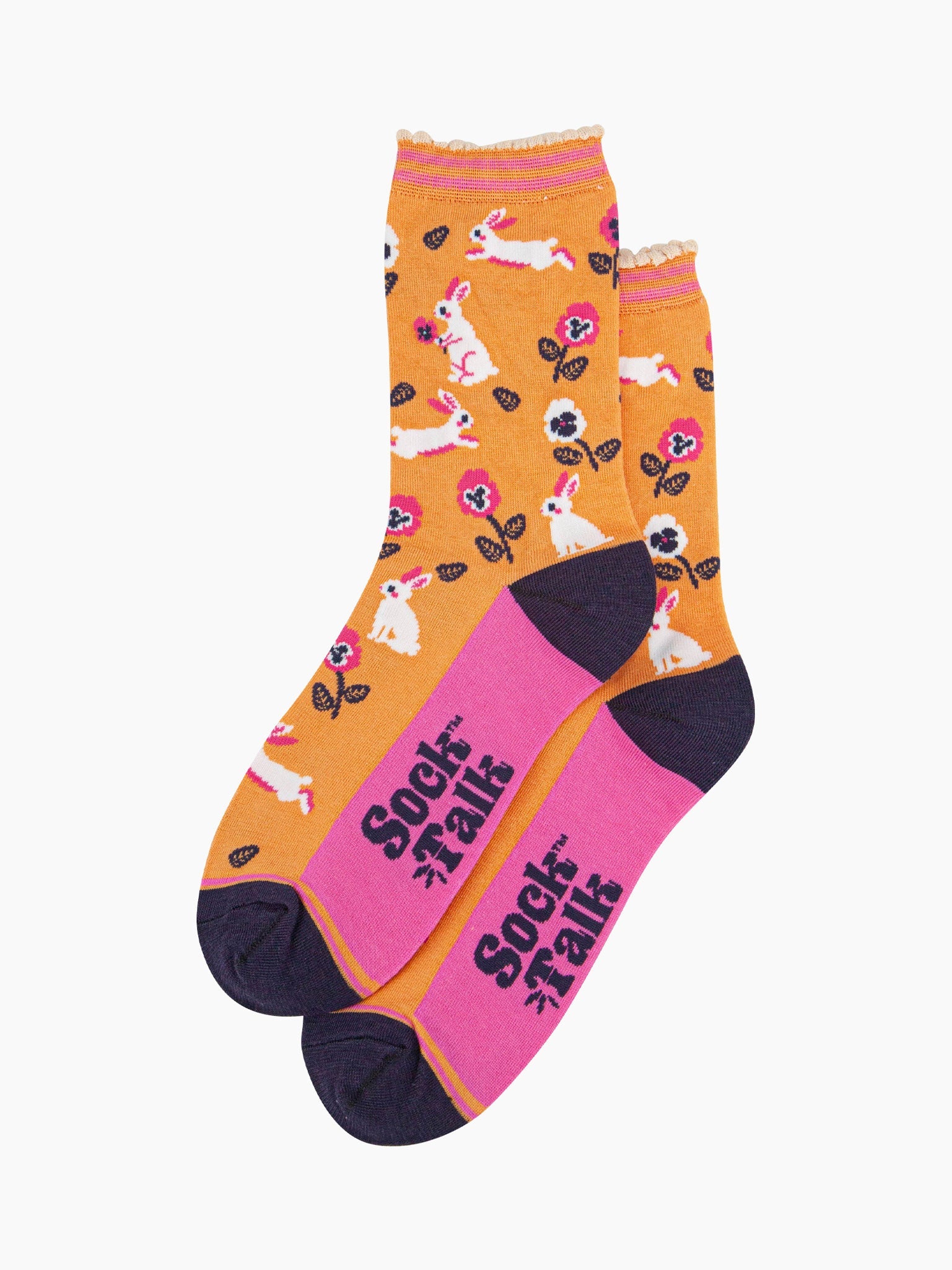 the pair of orange rabbit and flower socks laying flat, one on top of the other. showing clearly the all over pattern of white bunny rabbits, leaves and flowers.