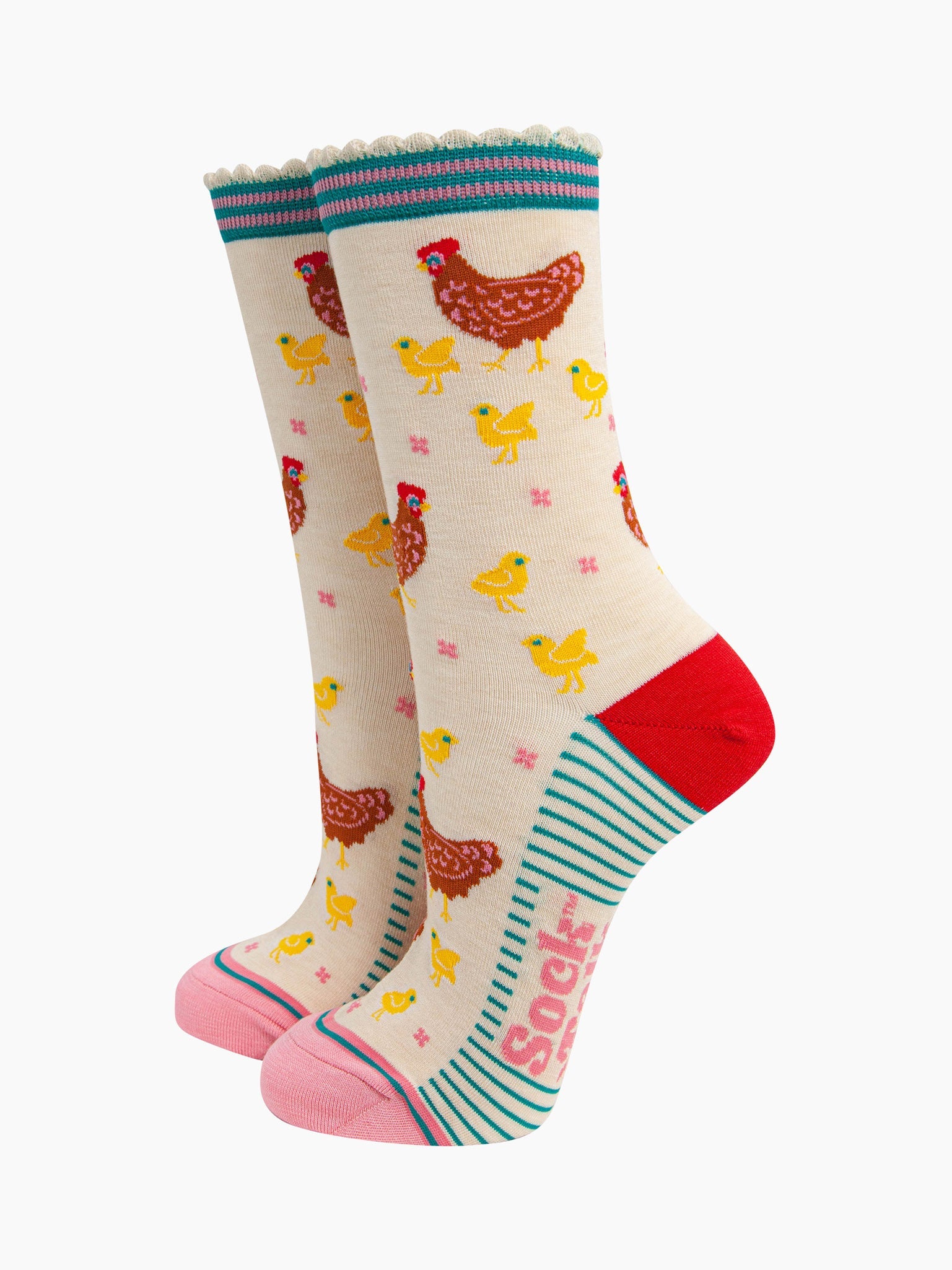 women's bamboo socks cream hen and chicks. cream bamboo socks with a pattern of brown mother hens with yellow baby chicks. the heel is red, the toe is light pink and the cuff is blue and pink striped.