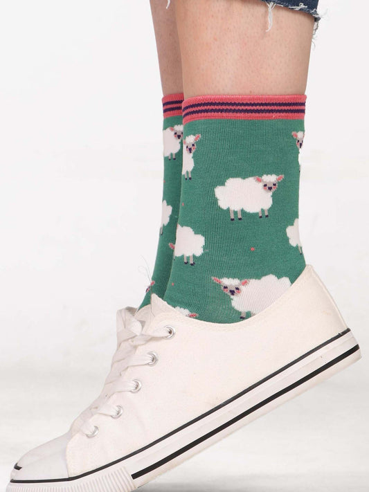 green ankle socks featuring a pattern of white woolly sheep lamb all over