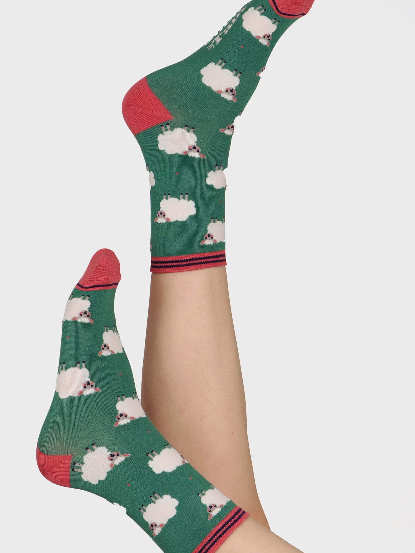 green ankle socks featuring a pattern of white woolly sheep lamb all over