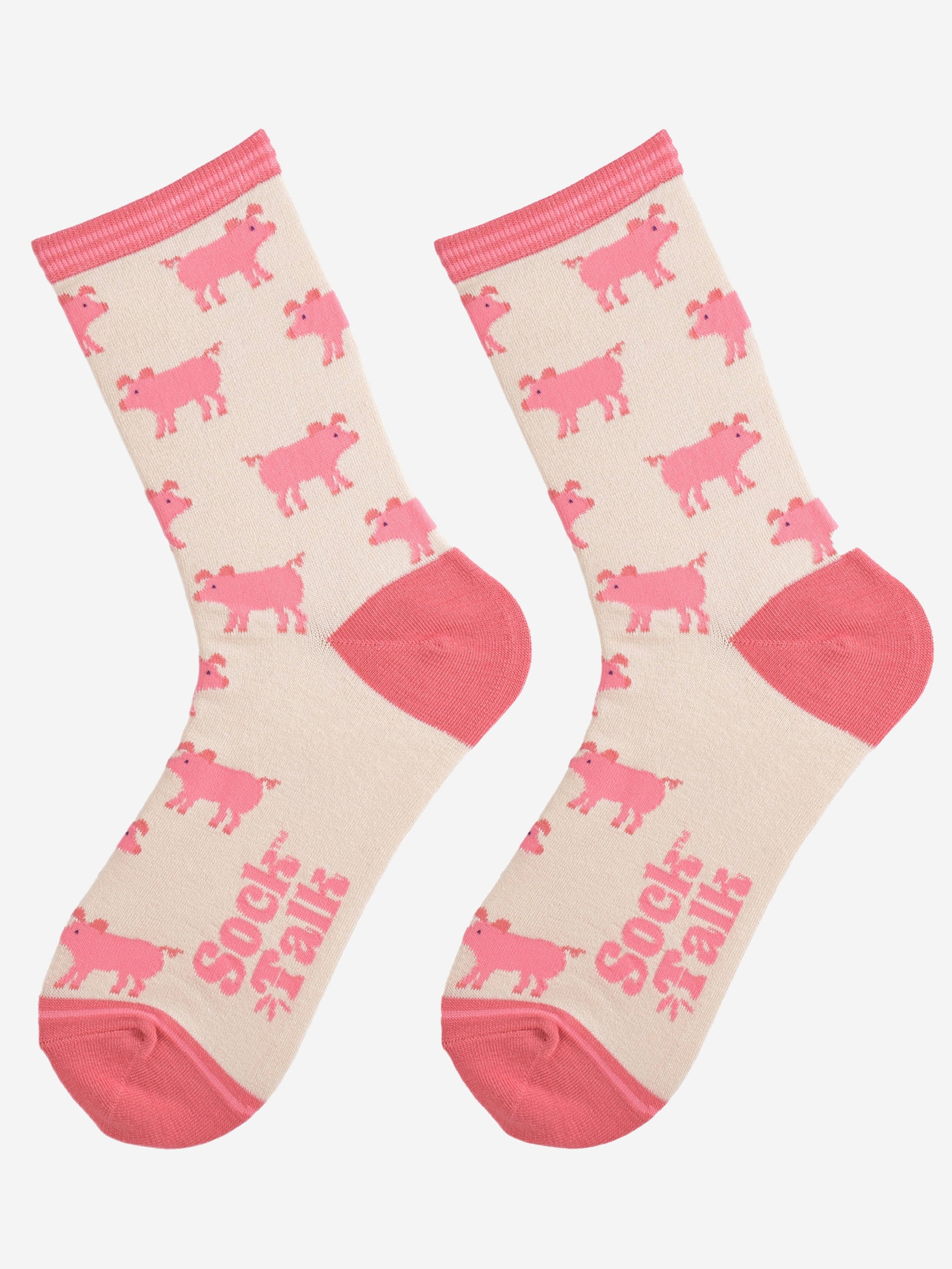 showing the cream and pink ladies pig socks laying flat, the pig pattern is all over the socks