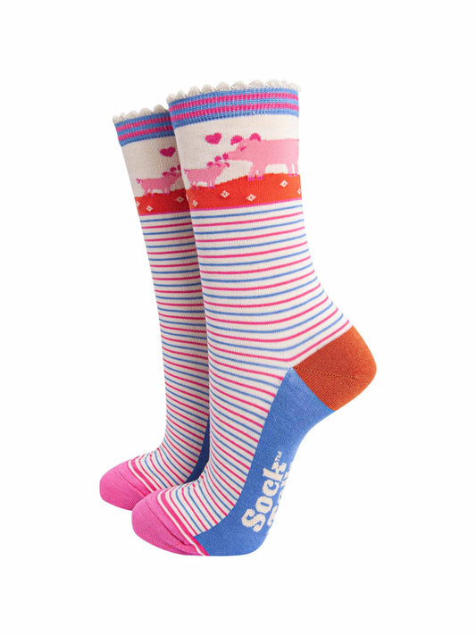 cream socks with pink and blue alternating horizontal pin stripes. the ankle features a mother pig and piglet in pink surrounded by pink love hearts