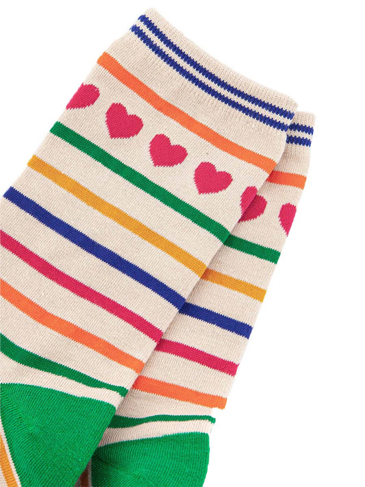 close up of the pink love heart detail around the ankle and the multicoloured rainbow stripes on the socks