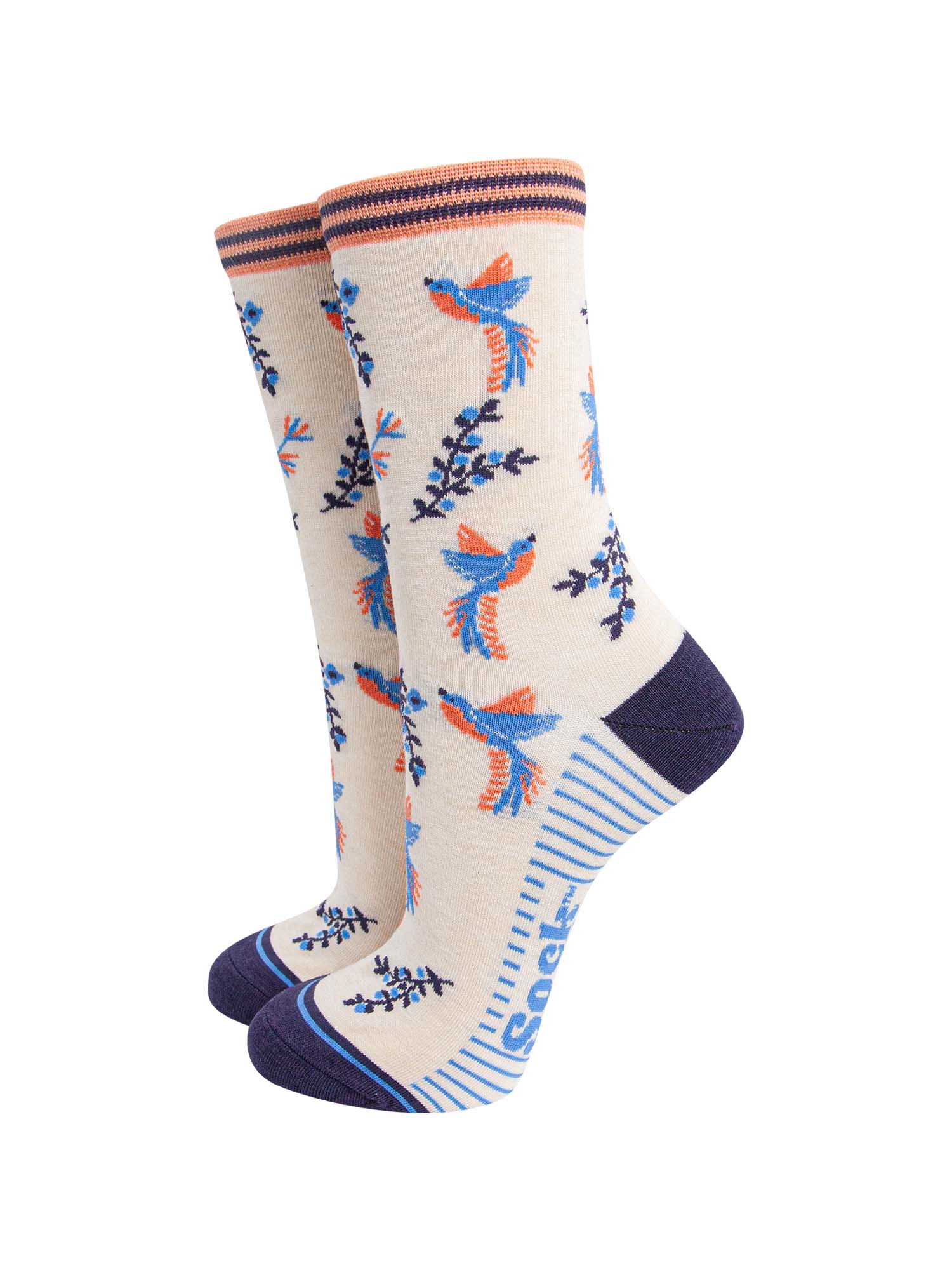 cream hummingbird floral bamboo socks. the hummingbirds and blue and orange and are shown in flight, hovering around floral vines. the toe and heel of the socks are a contrasting navy blue.