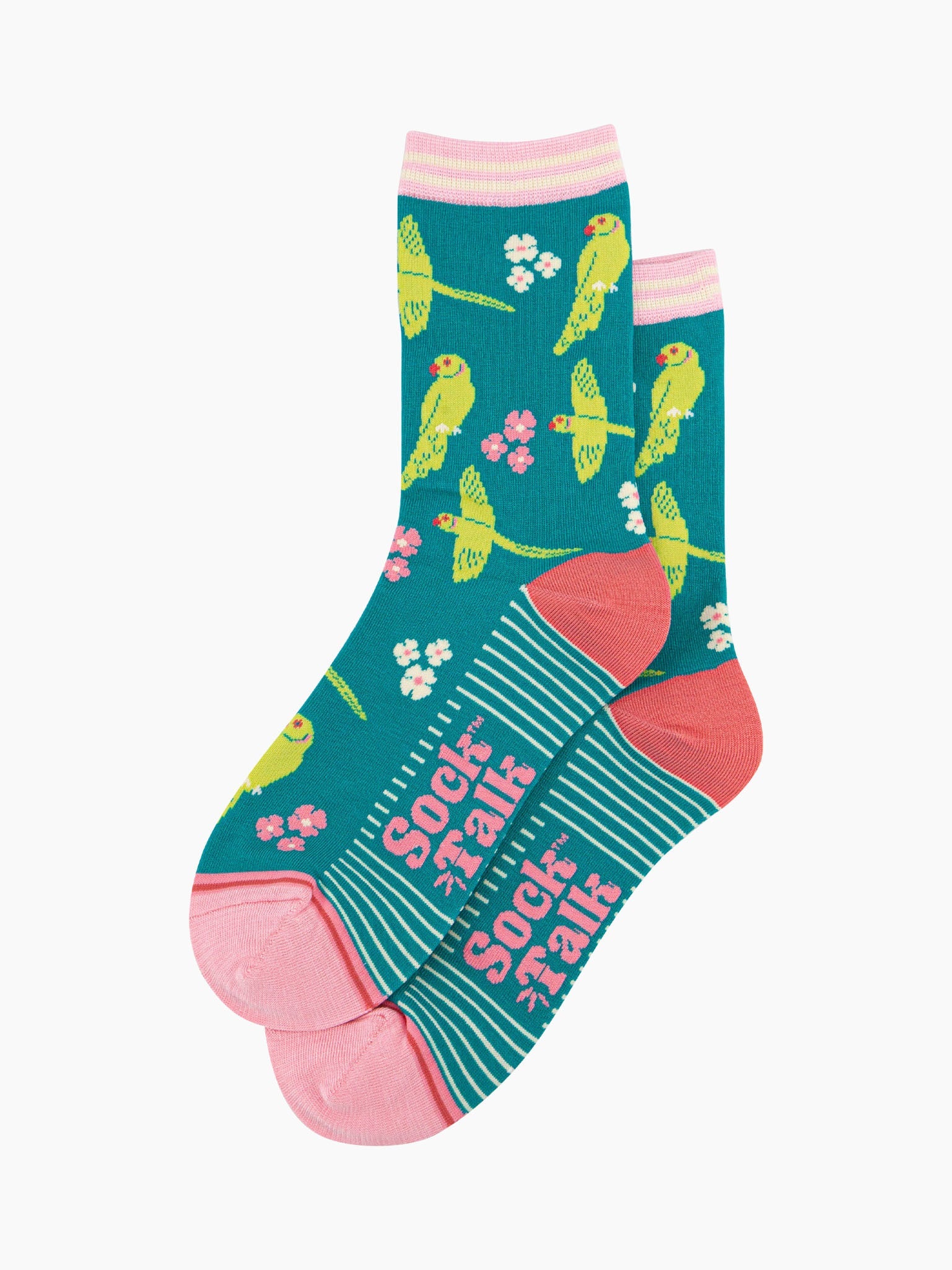 the pair of teal parakeet socks laying flat, one overlapping the other. showing clearly the teal blue background of the socks which is contrasted by the lime green parakeets and white and pink flowers. the sock talk logo is visible on the base of the sole. 