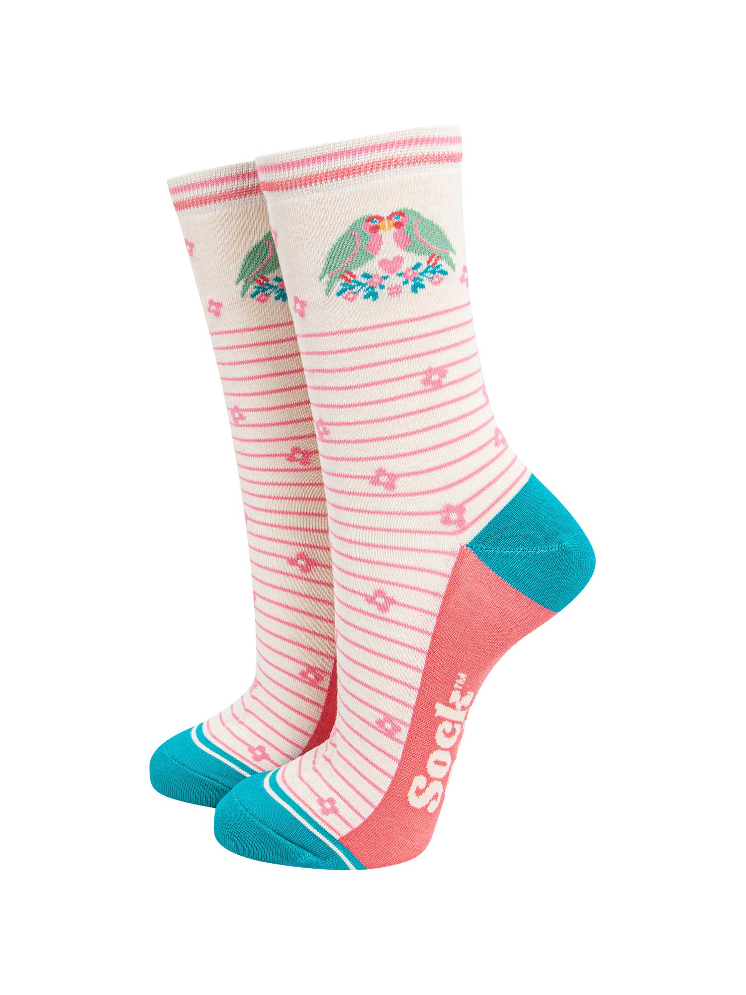 cream lovebird bamboo socks with a pink pinstripe pattern on the body of the socks. the heel and toe and aqua blue, the sole is coral pink. on the ankle of the socks there are a pair of green love birds perched on a floral branch.