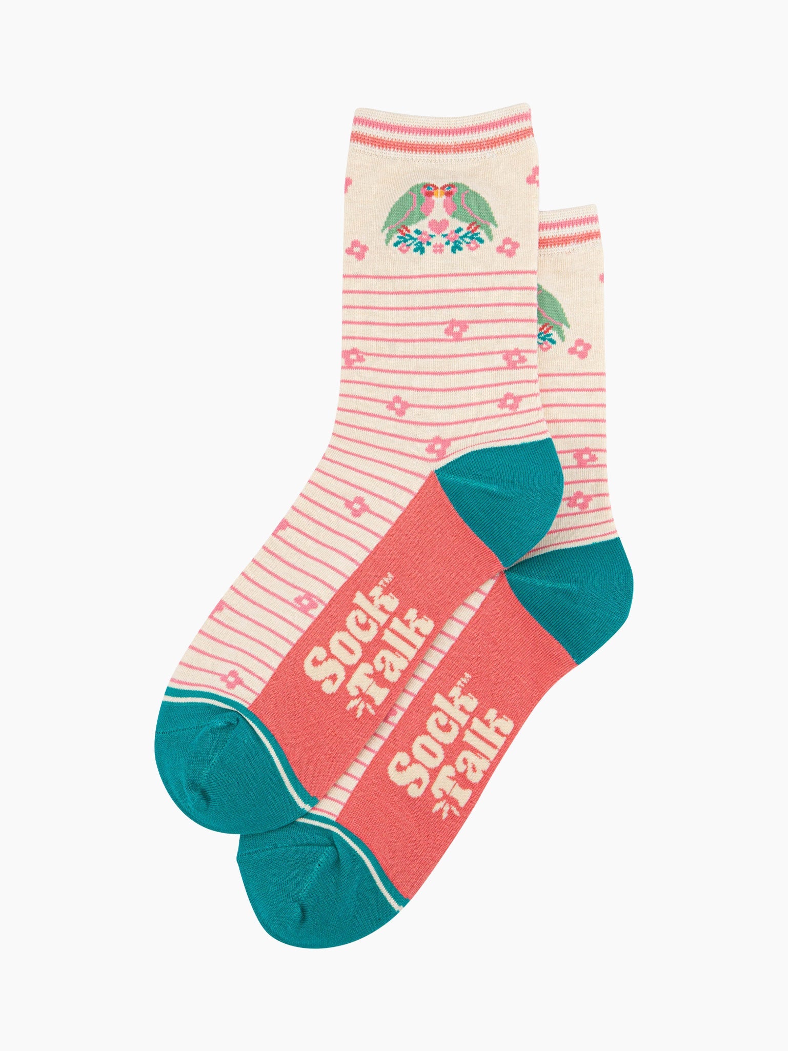 the pair of cream lovebird socks laying flat, one overlapping the other. showing clearly the cream background of the socks which is contrasted by light pink horizontal pinstripes. on the ankle there are two love birds facing each other, there is a pink love heart in the middle of them. the sock talk logo is cream visible on the base of the sole. 