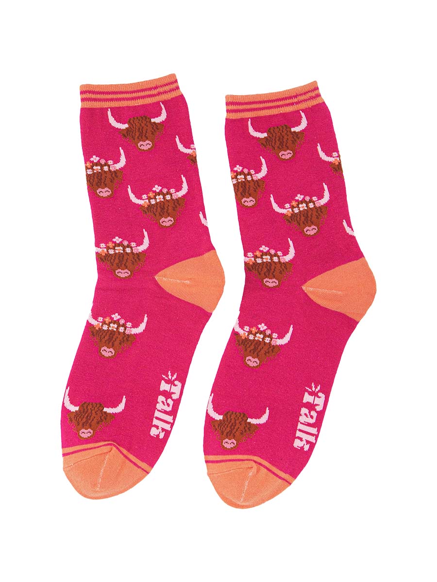 fuchsia pink bamboo socks with a pale orange heel, toe and cuff featuring a highland cattle pattern