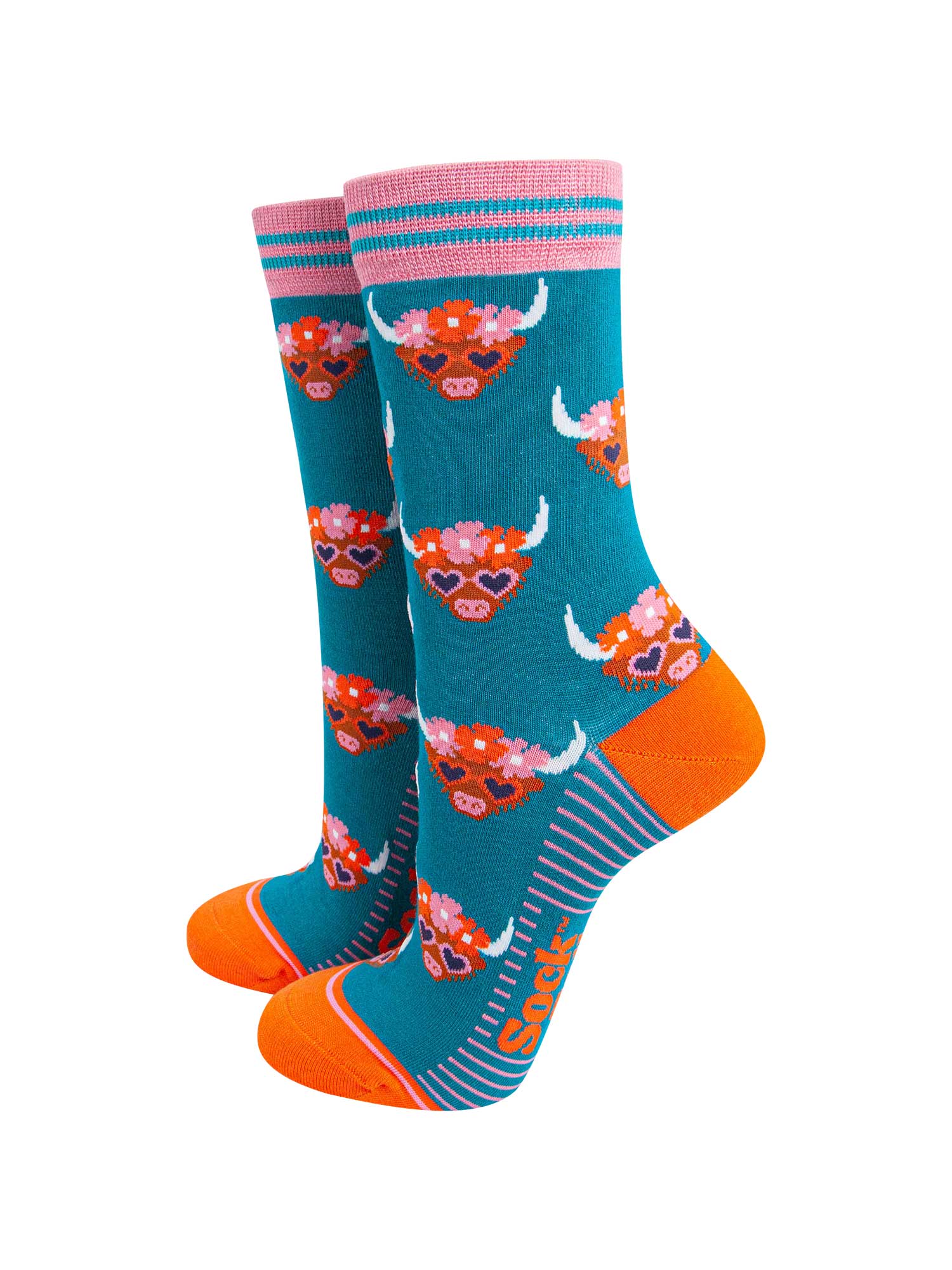 teal bamboo socks with an all over pattern of highland cows wearing floral crowns and love heart shaped sunglasses.